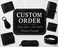 A promotional flat lay showing a customizable leather goods mockup set on a light textured background. In the center is a black leather patch with white text reading 'CUSTOM ORDER' and 'Preview Example'.