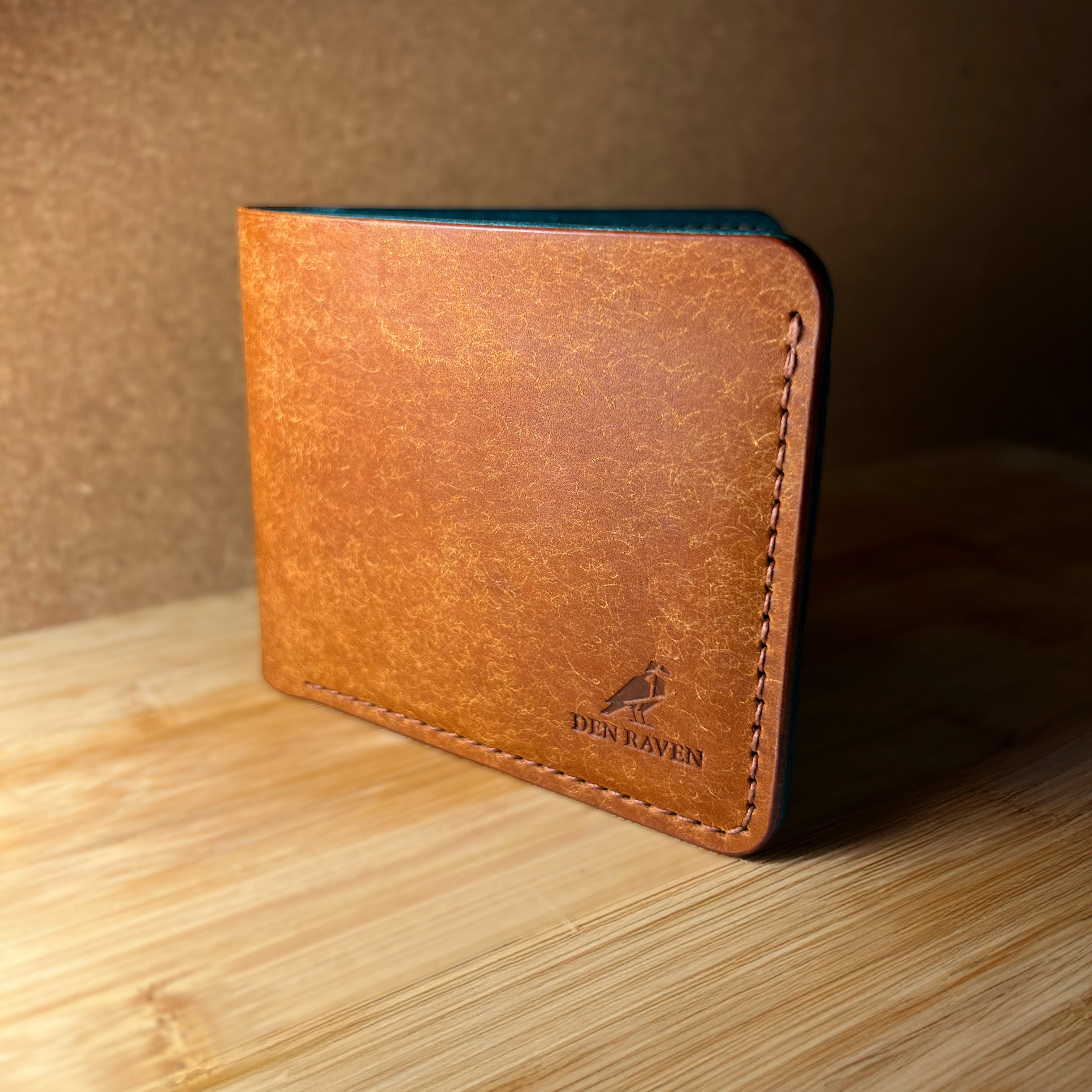 Brown leather wallet on a wooden surface with a brown background
