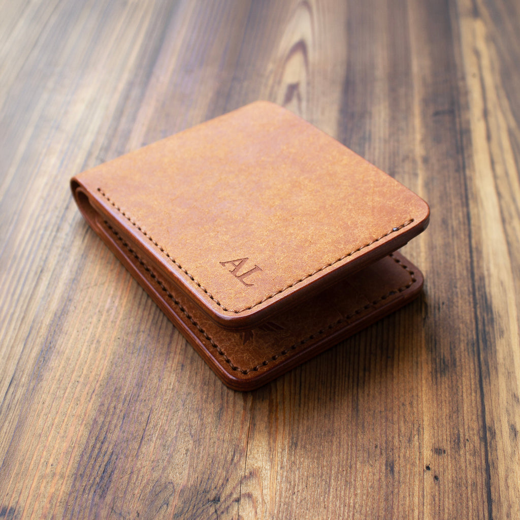 Brown leather wallet on a wooden surface