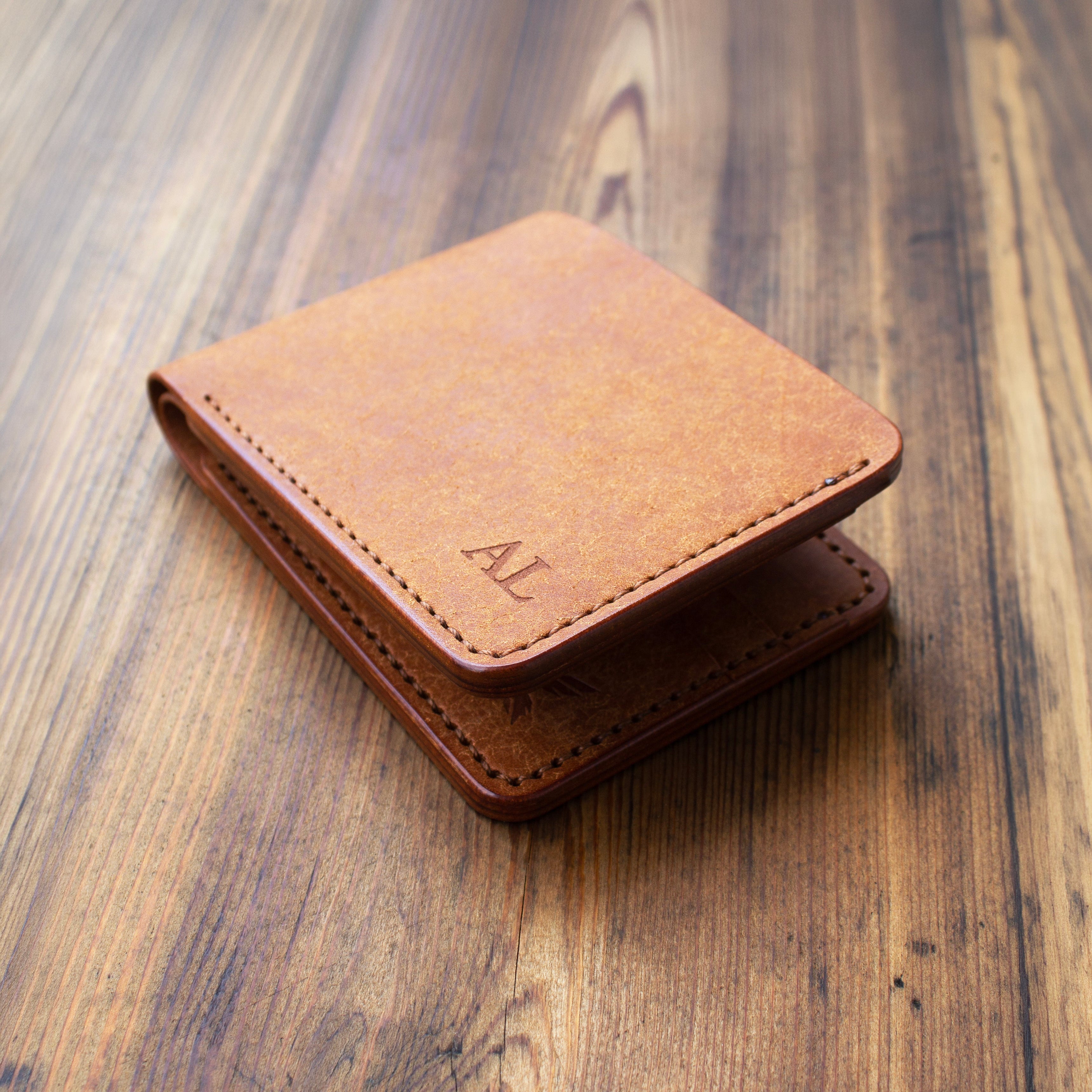 Brown leather wallet on a wooden surface