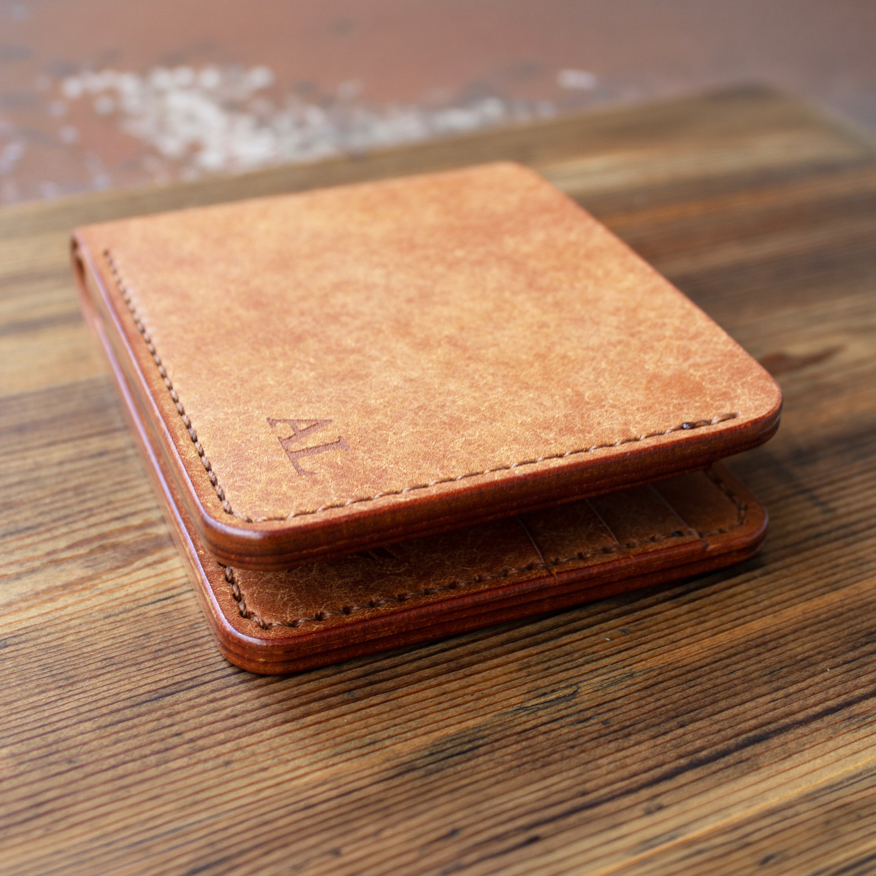 Brown leather wallet on a wooden surface