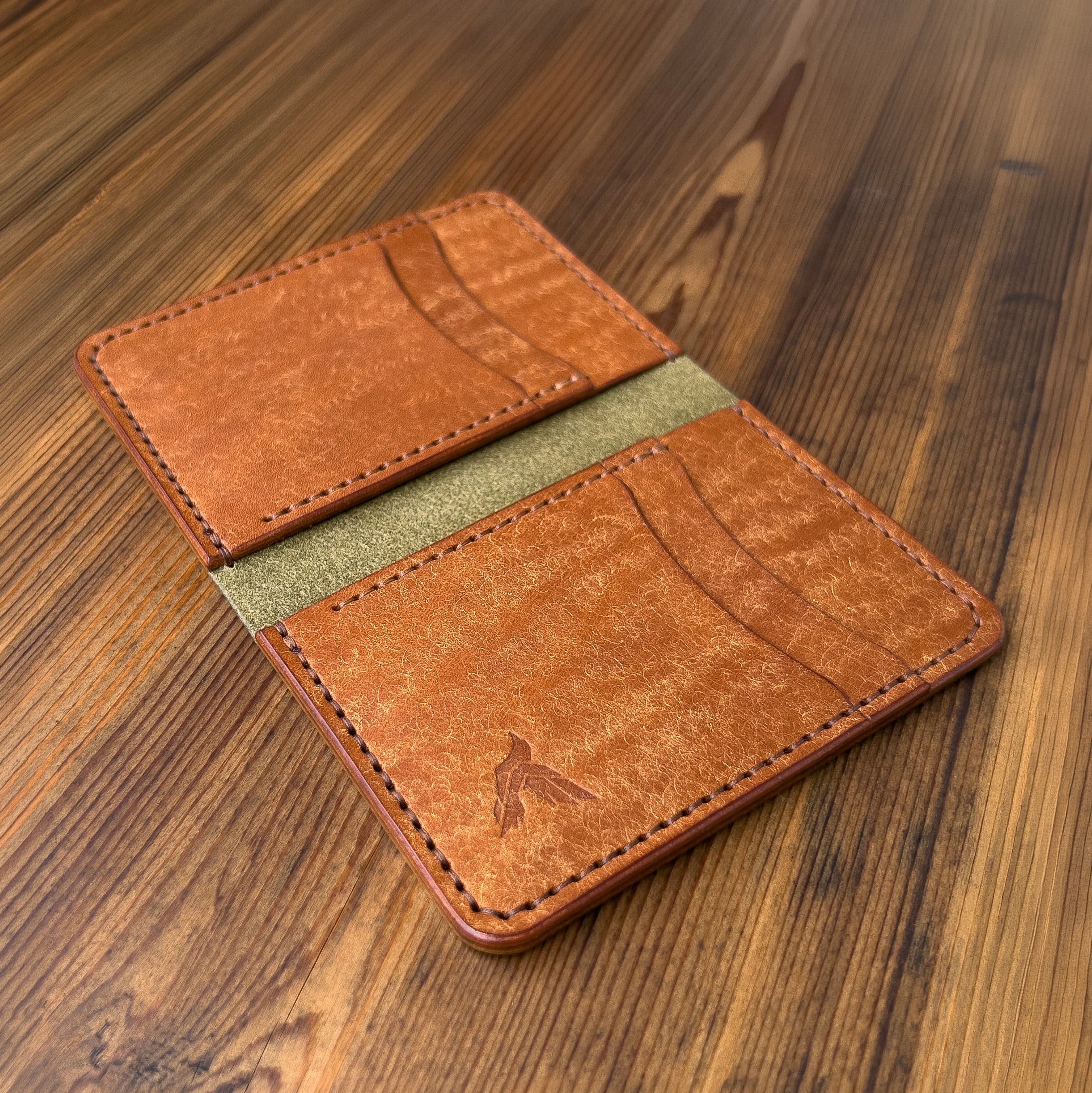 Brown leather wallet on a wooden surface