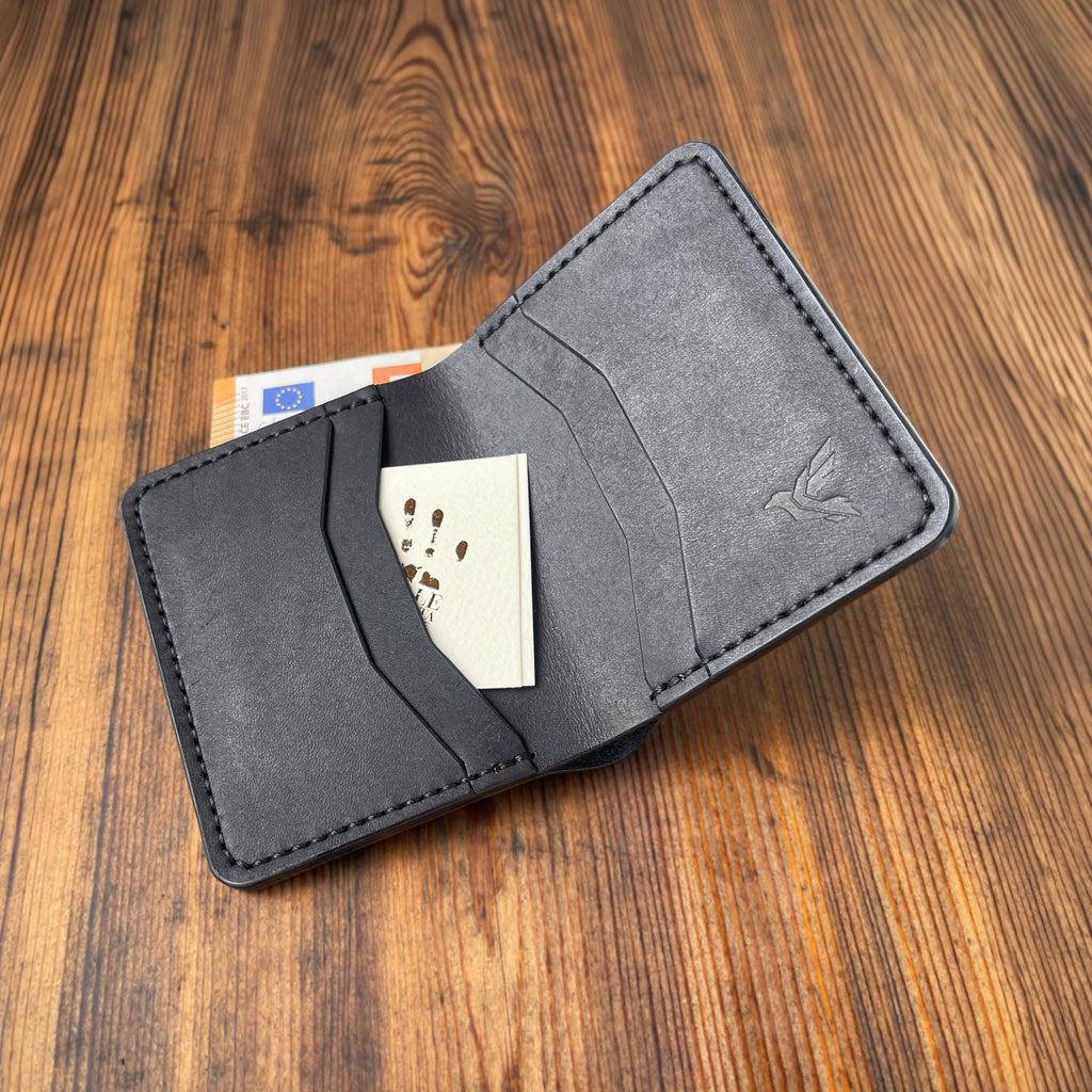 Gray wallet with cards on a wooden surface