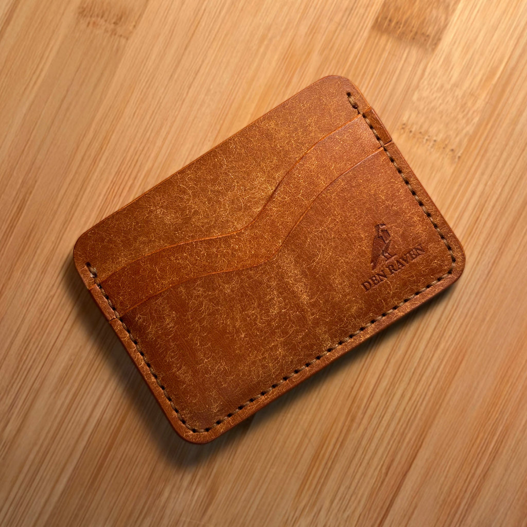 Brown leather wallet on a wooden surface