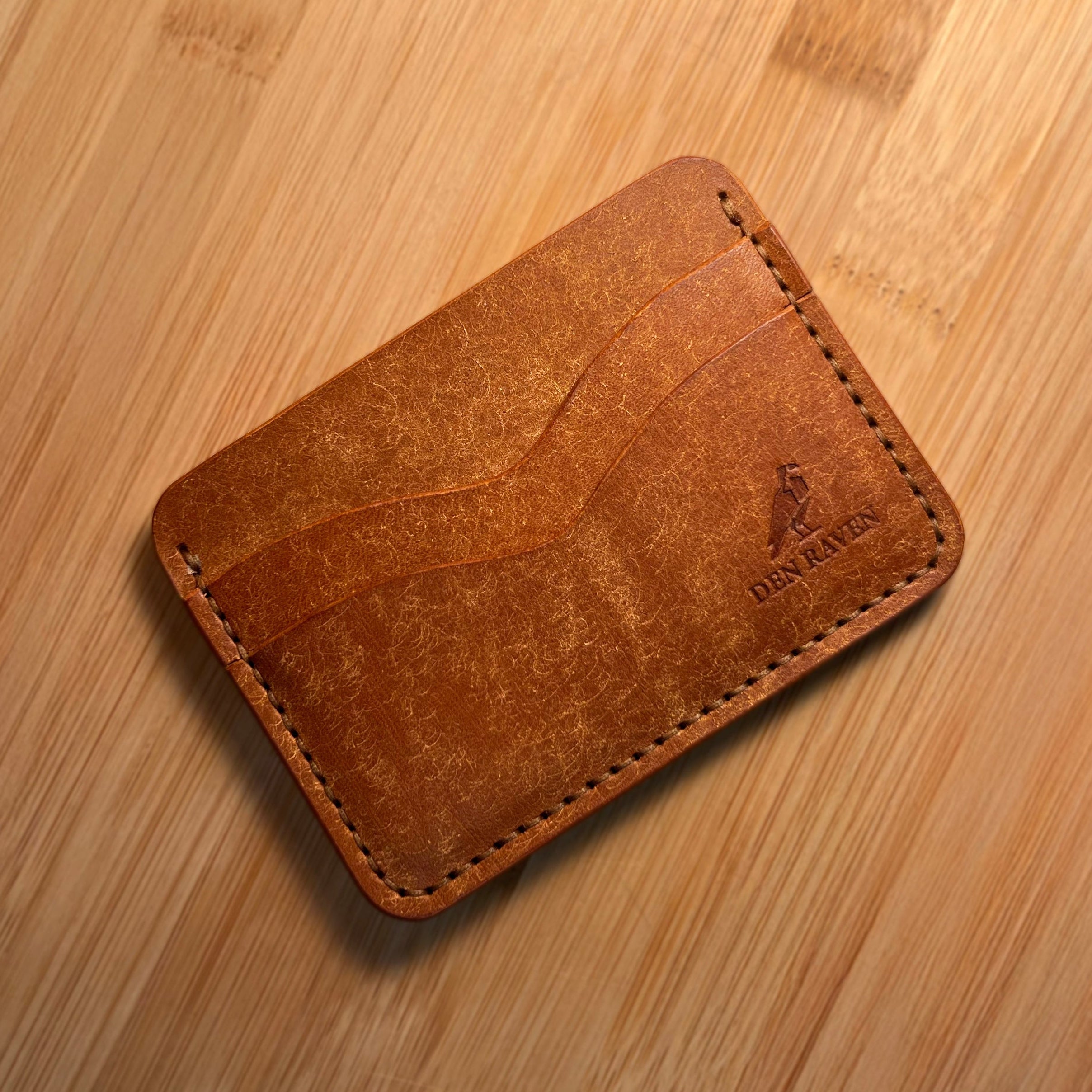 Brown leather wallet on a wooden surface