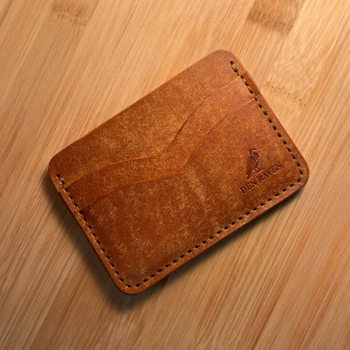 Brown leather wallet on a wooden surface