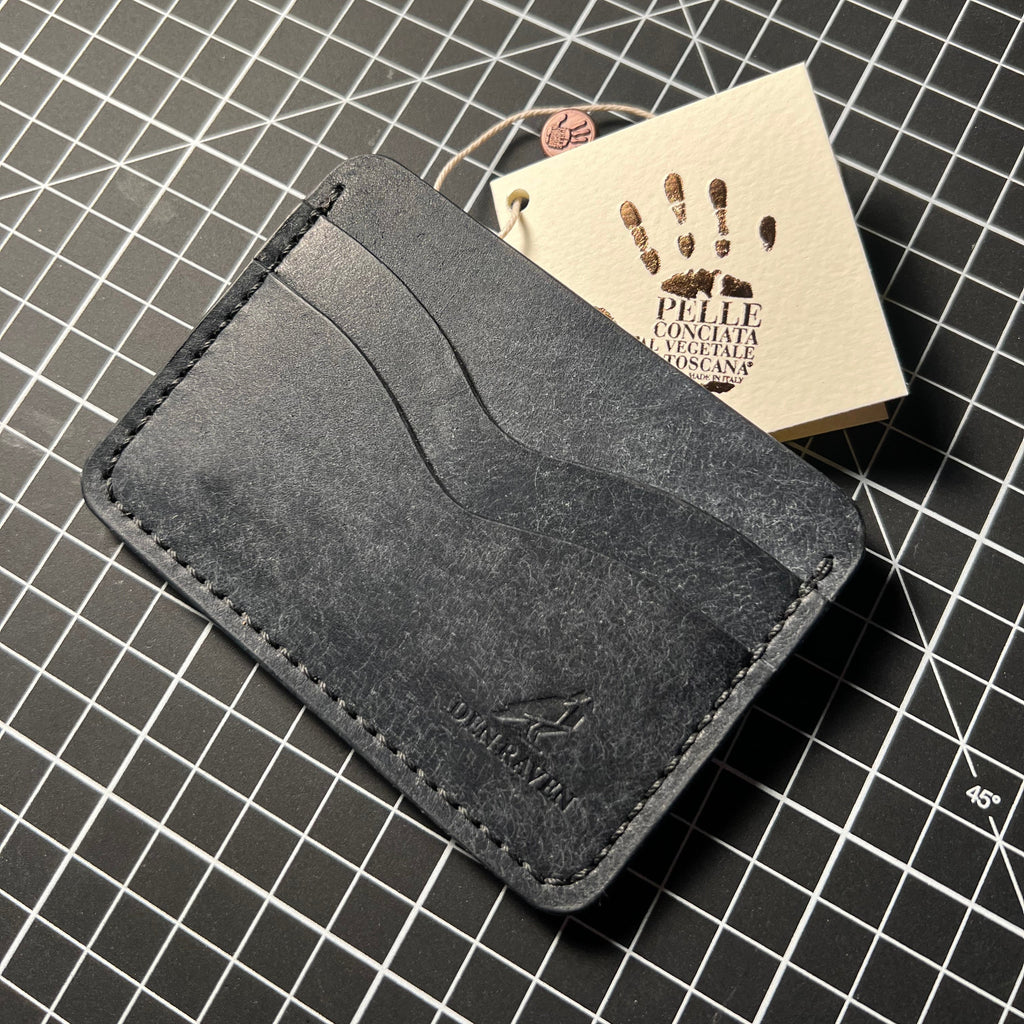 Black leather wallet on a grid surface