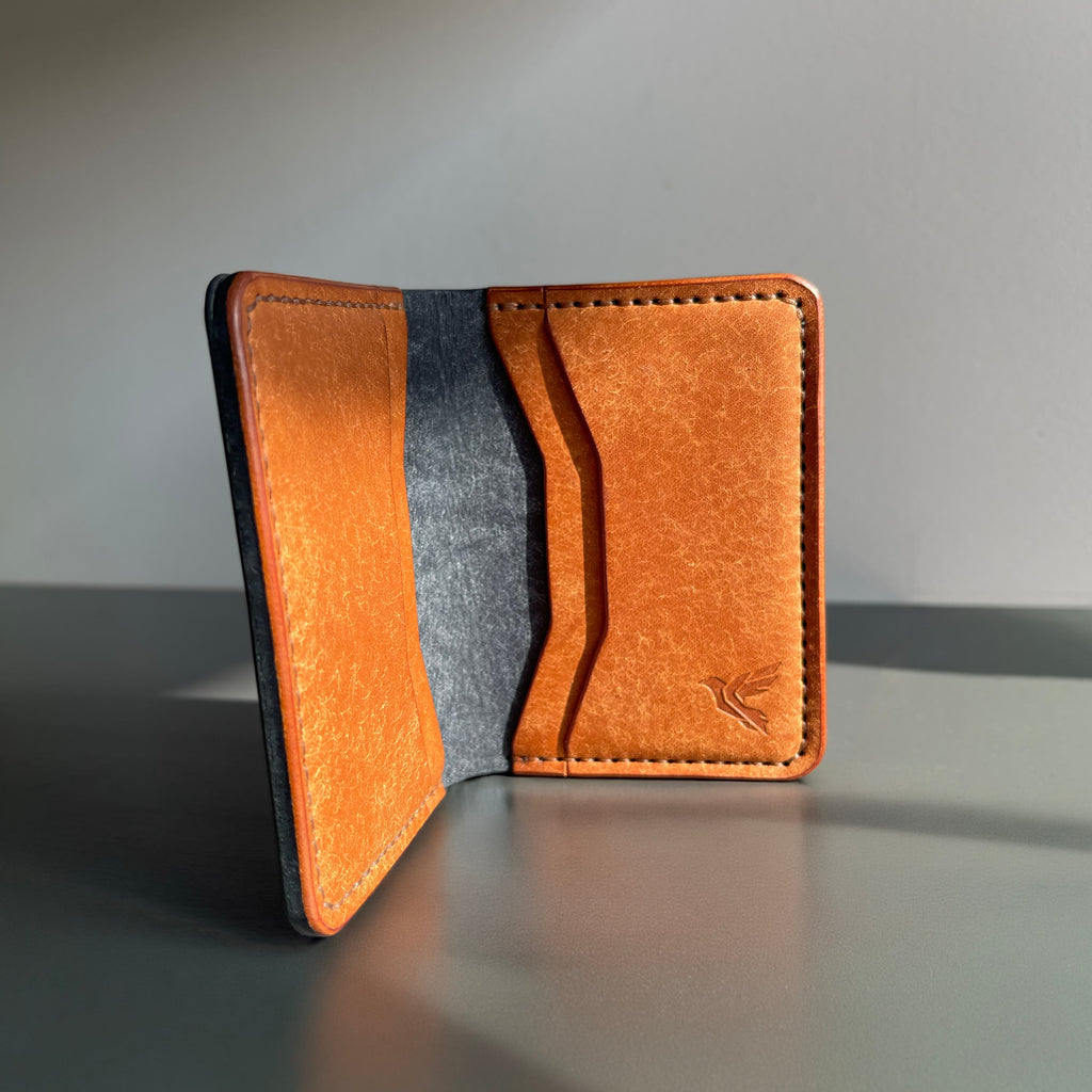 Brown leather wallet on a gray surface with a neutral background